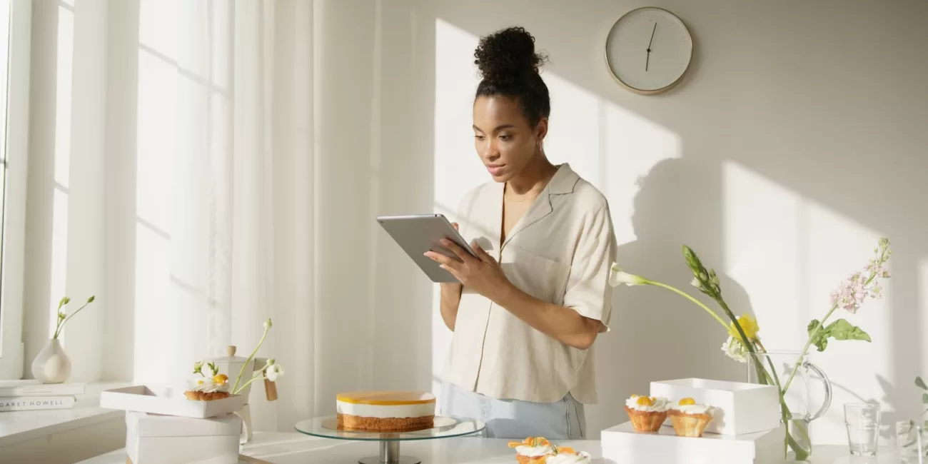 Man in White Shirt Using Silver Ipad